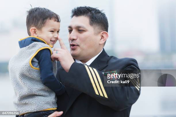 西班牙裔美國人的軍事人控股 2 歲的兒子 - 軍官 軍階 個照片及圖片檔
