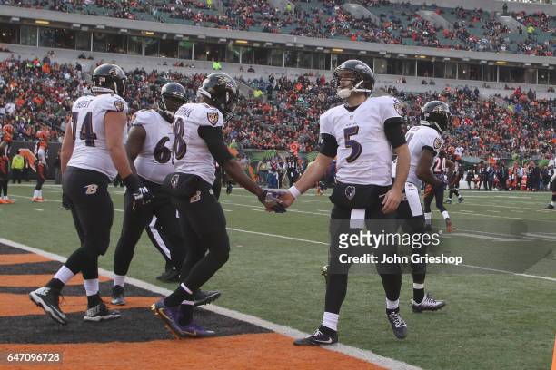 Joe Flacco of the Baltimore Ravens celebrates a touchdown with teammate Breshad Periman during their game against the Cincinnati Bengals at Paul...