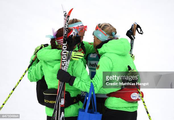 Katharina Hennig, Stefanie Boehler, Nicole Fessel and Sandra Ringwald of Germany embrace after the Women's Cross Country 4x5km Relay at the FIS...