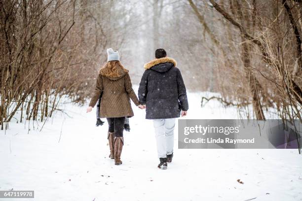 young couple walking in a footpath during winter - quebec icy trail stock pictures, royalty-free photos & images