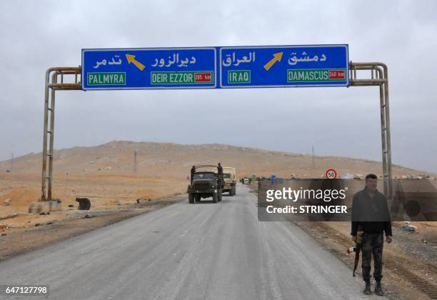 Picture taken on March 2 shows a sign displaying the routes to Palmyra-Deir Ezzor and Damascus-Iraq as Syrian regime fighters advance to retake the...