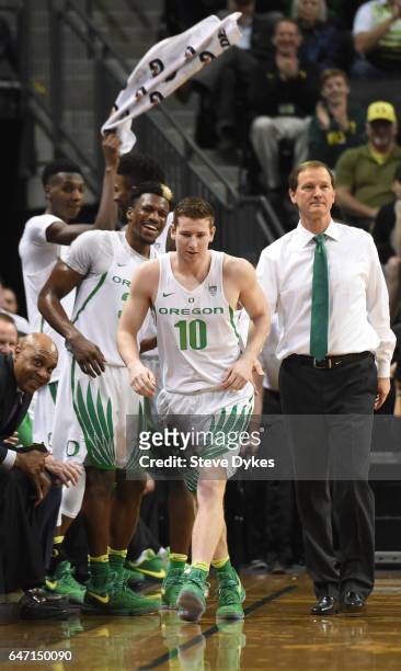 The Oregon Ducks bench cheer as Charlie Noebel of the Oregon Ducks gets into the game late in the second half against the Colorado Buffaloes at...