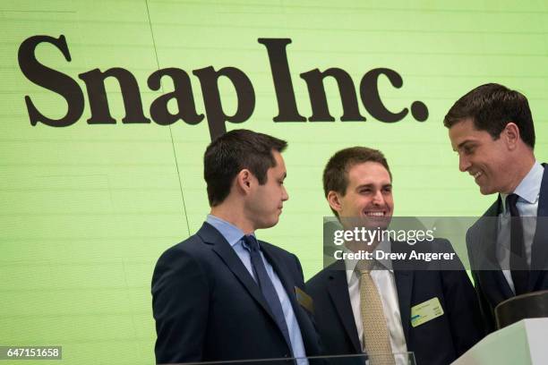 Snapchat co-founders Bobby Murphy, chief technology officer of Snap Inc., and Evan Spiegel, chief executive officer of Snap Inc., smile at each other...