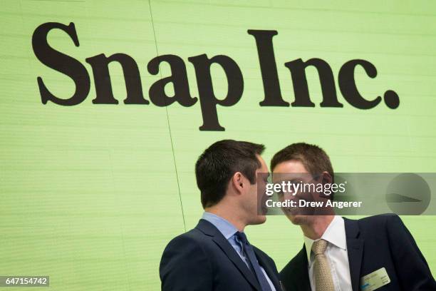 Snapchat co-founders Bobby Murphy, chief technology officer of Snap Inc., and Evan Spiegel, chief executive officer of Snap Inc., smile at each other...