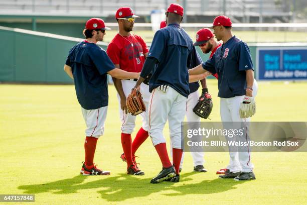 Chris Young, Andrew Benintendi, and Mookie Betts among other outfielders of the Boston Red Sox talk before a Spring Training game against the Tampa...