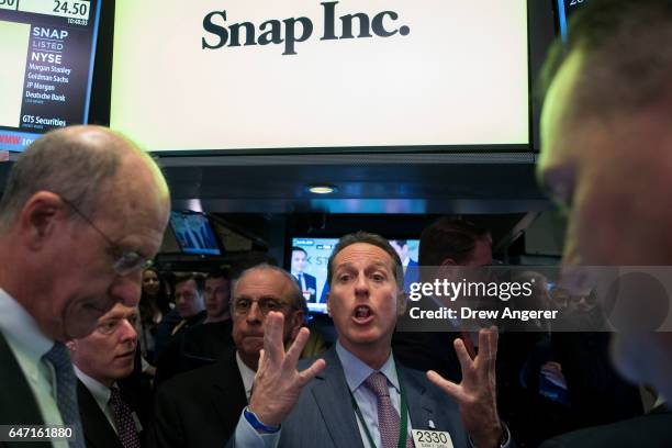 Traders work as they wait for shares of Snap Inc. To open for trading on the floor of the New York Stock Exchange , March 2, 2017 in New York City....