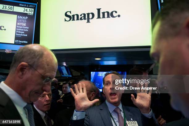 Traders work as they wait for shares of Snap Inc. To open for trading on the floor of the New York Stock Exchange , March 2, 2017 in New York City....