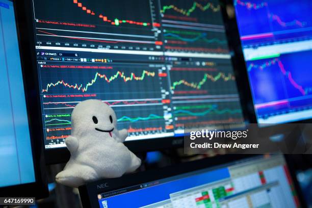 Snapchat logo stuffed animal sits on the desk of a trader on the floor of the New York Stock Exchange , March 2, 2017 in New York City. Snap Inc....