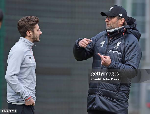 Jurgen Klopp manager of Liverpool talks with Adam Lallana of Liverpool during a training session at Melwood Training Ground on March 2, 2017 in...