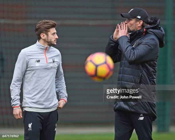Jurgen Klopp manager of Liverpool talks with Adam Lallana of Liverpool during a training session at Melwood Training Ground on March 2, 2017 in...