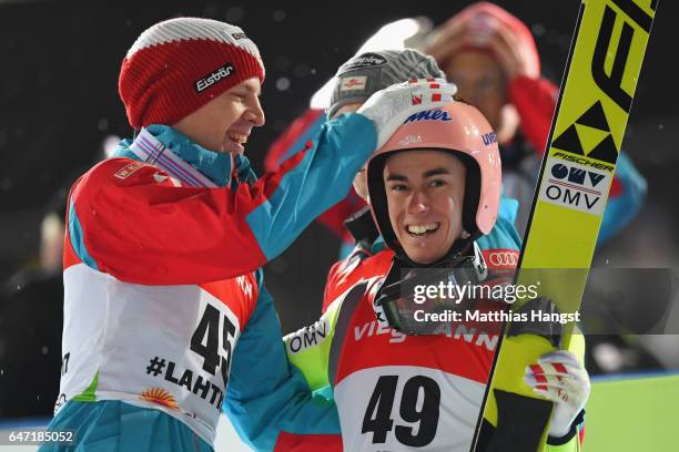 Stefan Kraft of Austria is congratulated by Michael Hayboeck of Austria as he wins gold during the Men's Ski Jumping HS130 at the FIS Nordic World...