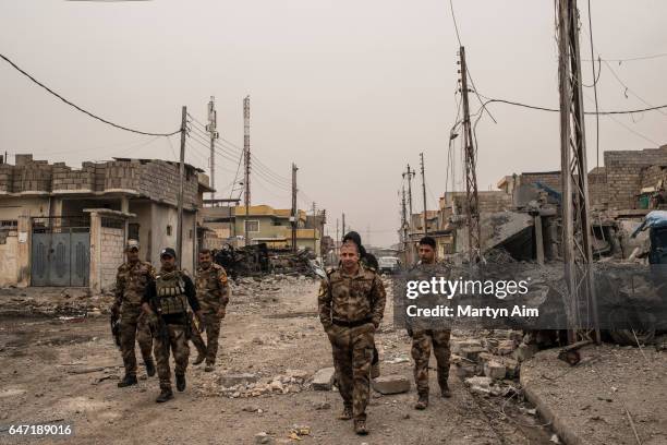 Iraqi Counter Terrorism Service officers of the Golden Division advance into the west Mosul district of al-Mamoun, part of the offensive to retake...