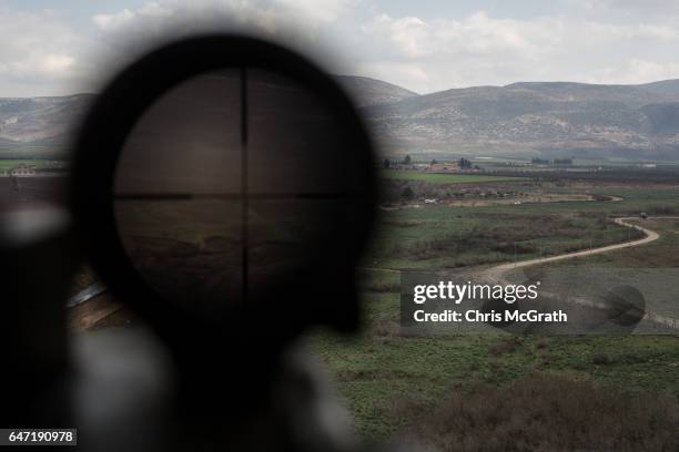 Syria is seen through a high powered scope situated on a tower at a 1st Border Regiment Command outpost during military drills on the Turkey/Syria...