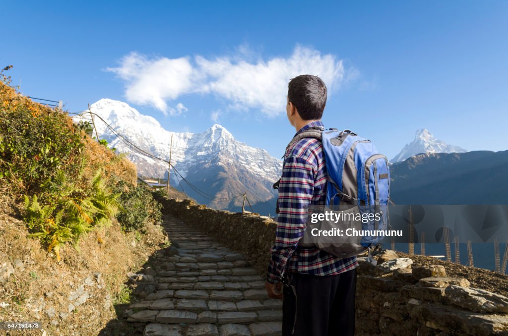 Hiker looking to way leading to mountains