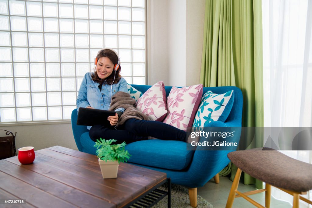 Young woman watching a movie at home