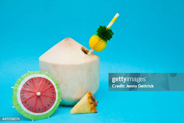 cocktail in a coconut - cocktail umbrella stock pictures, royalty-free photos & images