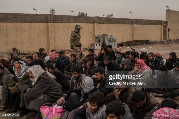 Iraqi men who have fled fighting in west Mosul between Islamic State and Iraqi forces have been separated from their families to be registered and...