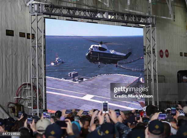 Members of the U.S. Navy and shipyard workers watch as Marine One carrying U.S. President Donald Trump lands on the deck of USS Gerald R. Ford CVN 78...