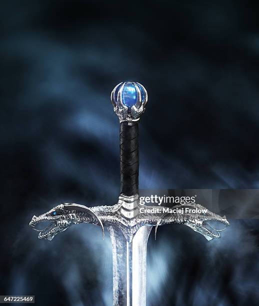 long sword with dragon`s heads on guard - sword in the stone stock-grafiken, -clipart, -cartoons und -symbole