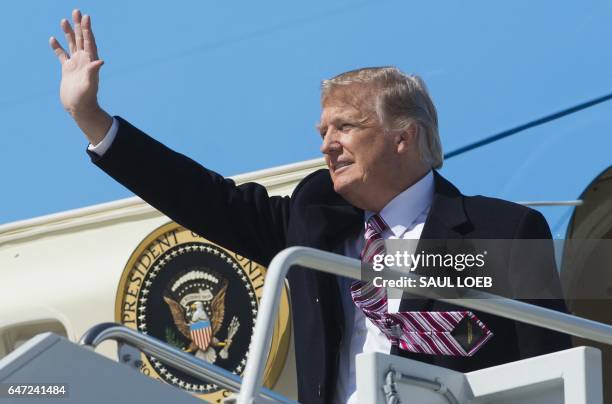 President Donald Trump waves from Air Force One upon arrival at Langley Air Force Base in Virginia, March 2 as he travels to Newport News, Virginia,...