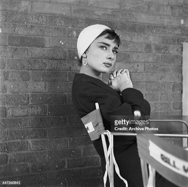 Belgian-born actress Audrey Hepburn on the set of director Billy Wilder's film, 'Sabrina' , New York, October 1953. She is wearing a skirt suit and...