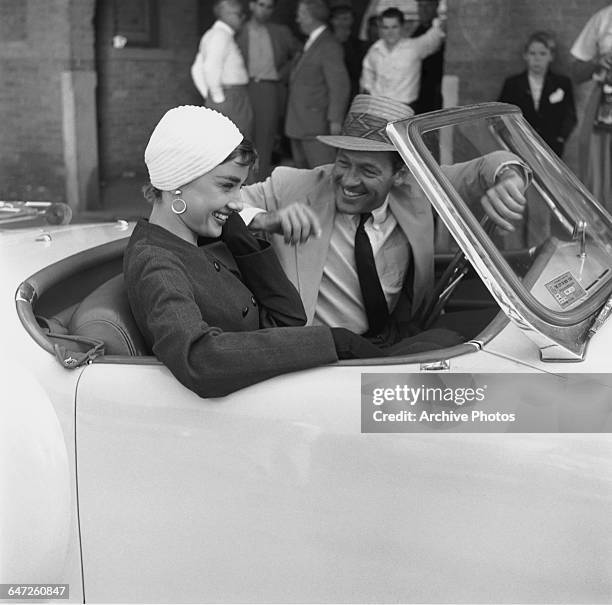 Actors Audrey Hepburn and William Holden in a Nash-Healey roadster on the set of director Billy Wilder's film, 'Sabrina' , New York, October 1953....