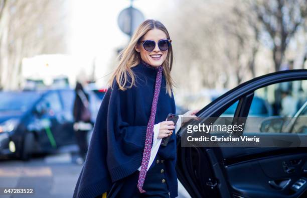 Olivia Palermo wearing a navy knit outside Chloe on March 2, 2017 in Paris, France.