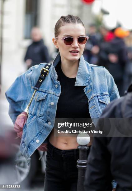 Model Lily Donaldson with braids and cropped top outside Balmain on March 2, 2017 in Paris, France.