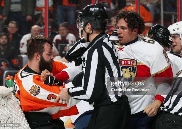 Linesman Bevan Mills breaks up a scrum between Radko Gudas of the Philadelphia Flyers and Alex Petrovic of the Florida Panthers on March 2, 2017 at...