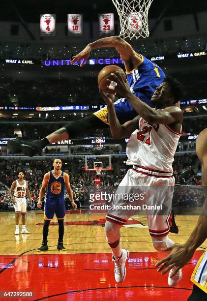 JaVale McGee of the Golden State Warriors fouls Jimmy Butler of the Chicago Bulls at the United Center on March 2, 2017 in Chicago, Illinois. NOTE TO...