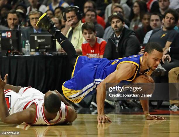Stephen Curry of the Golden State Warriors hits the floor after being fouled by Rajon Rondo of the Chicago Bulls at the United Center on March 2,...