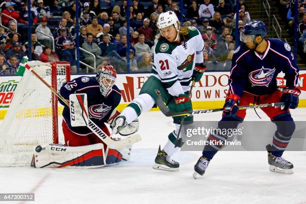 Seth Jones of the Columbus Blue Jackets watches as Sergei Bobrovsky of the Columbus Blue Jackets makes a save while being screened by Ryan White of...