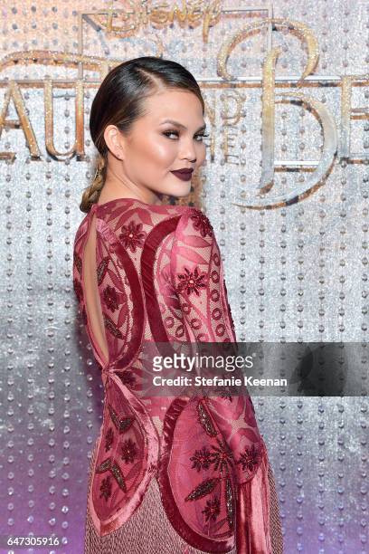 Chrissy Teigen arrives at the world premiere of Disney's new live-action "Beauty and the Beast" photographed in front of the Swarovski crystal wall...