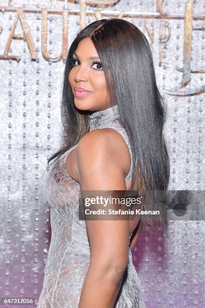 Toni Braxton arrives at the world premiere of Disney's new live-action "Beauty and the Beast" photographed in front of the Swarovski crystal wall at...