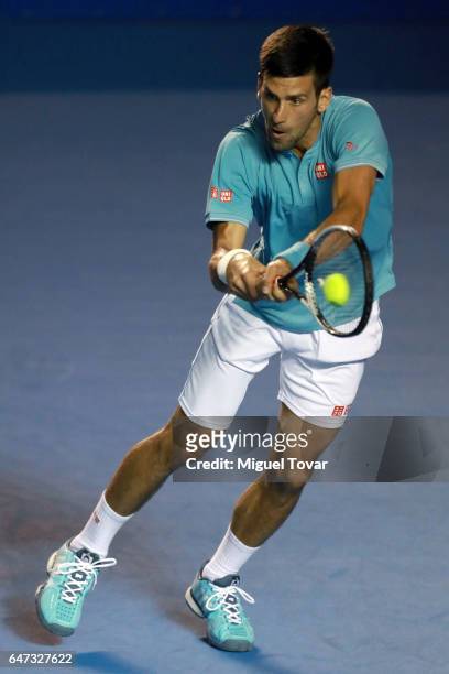 Novak Djokovic of Serbia plays a backhand during the match between Novak Djokovic of Serbia and Nick Kyrgios of Australia as part of the Abierto...