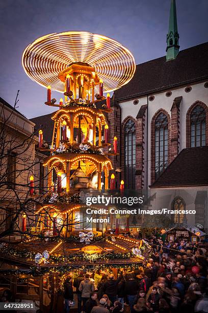 crowds of people at christmas market illuminated at night basel, switzerland - basel switzerland stock pictures, royalty-free photos & images