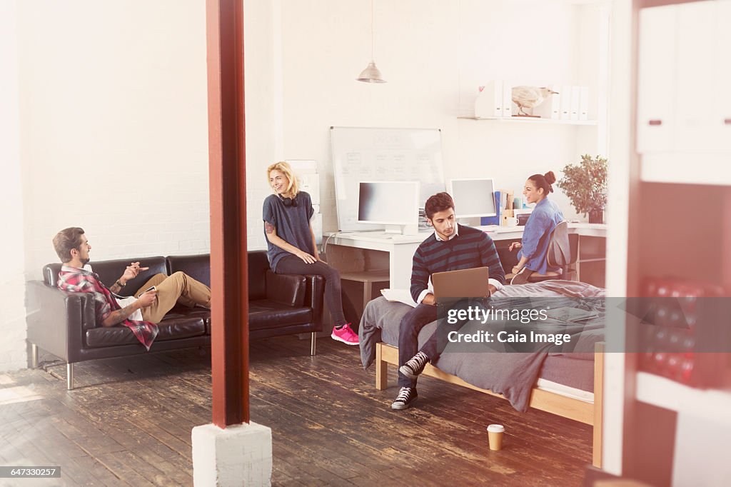 Young adult friends hanging out in loft apartment