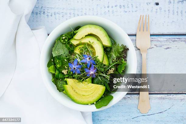 detox bowl of different lettuces, vegetables, cress, quinoa, avocado and starflowers - rucola stock-fotos und bilder