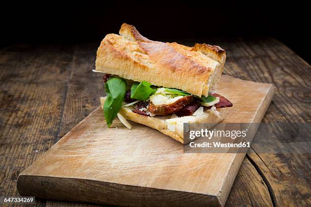 sandwich, french white bread, smoked ham, basil, dried tomate and parmesan - sandwich baguette stock pictures, royalty-free photos & images