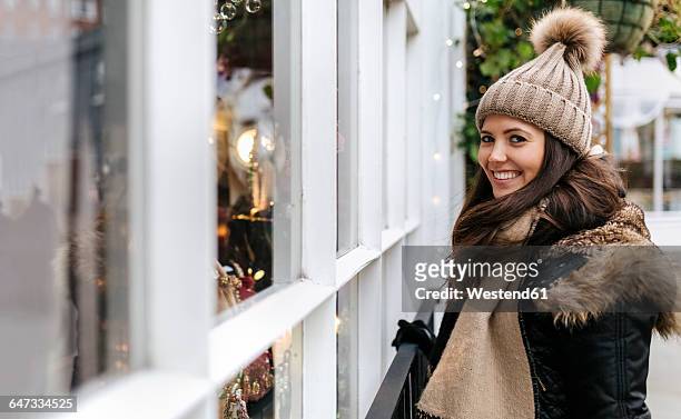 uk, london, notting hill, portrait of happy young woman beside window display - the 2016 notting hill carnival stock pictures, royalty-free photos & images