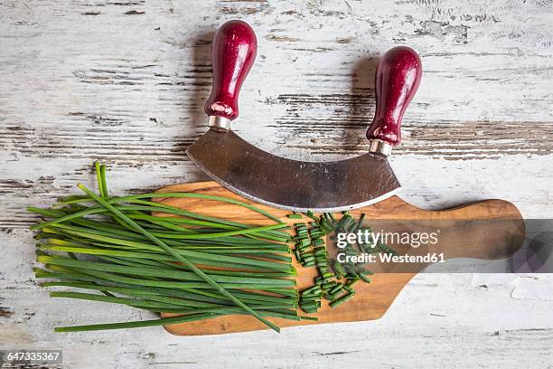 chives, mezzaluna and wooden board on wood - mincing knife stock pictures, royalty-free photos & images