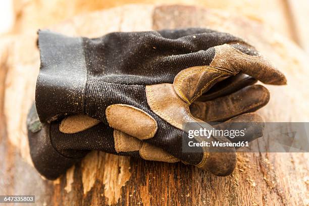 work gloves on wood block in wood carver's workshop - work glove stock pictures, royalty-free photos & images