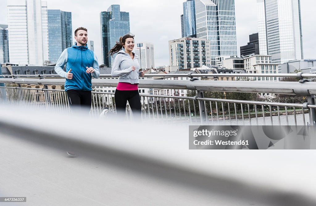 Young couple running at the river