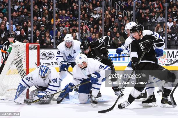 Frederik Andersen of the Toronto Maple Leafs makes a save with help from Alexey Marchenko and Morgan Rielly as they battle against Tyler Toffoli and...