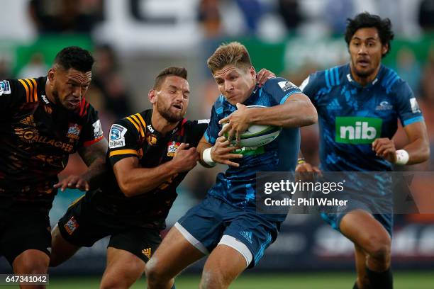 Piers Francis of the Blues is tackled by Aaron Cruden of the Chiefs during the round two Super Rugby match between the Chiefs and the Blues at Rugby...