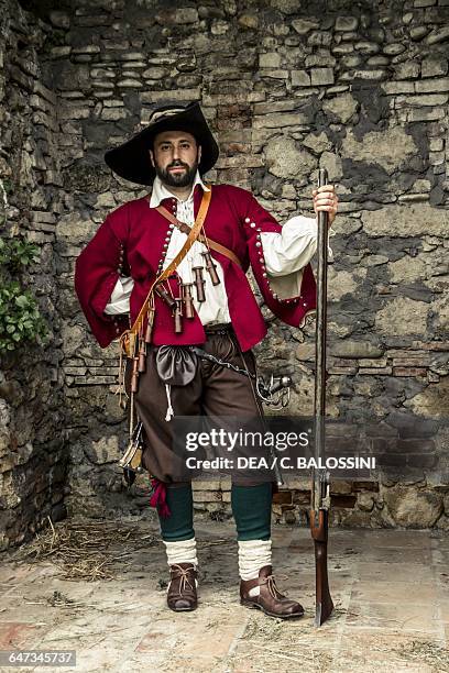 Picaro with arquebus and sword, with wooden powder canisters hanging from his powder bandolier. Spain, 16th century. Historical reenactment.