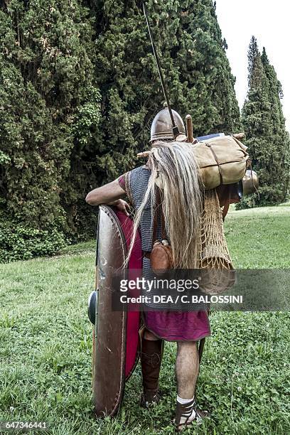Roman soldiers marching to a camp with weapons and supplies, Republican period, Friuli-Venezia Giulia, Italy. Roman Empire. Historical reenactment.