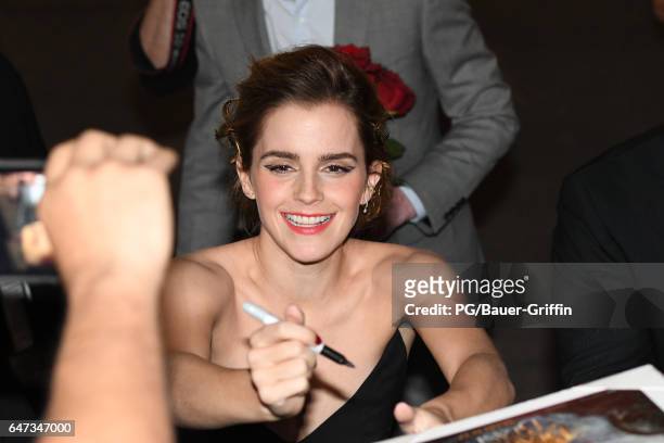 Emma Watson is seen signing autographs for fans as she arrives at the premiere of "Beauty and the Beast" on March 02, 2017 in Los Angeles, California.