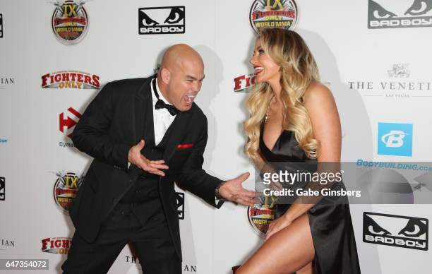 Mixed martial artist Tito Ortiz jokes around with television personality Amber Nichole Miller as they attend the ninth annual Fighters Only World...