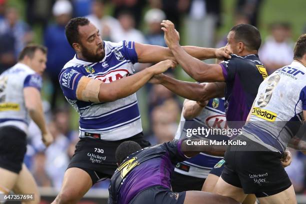 Sam Kasiano of the Bulldogs and Will Chambers of the Storm fight during the round one NRL match between the Canterbury Bulldogs and the Melbourne...